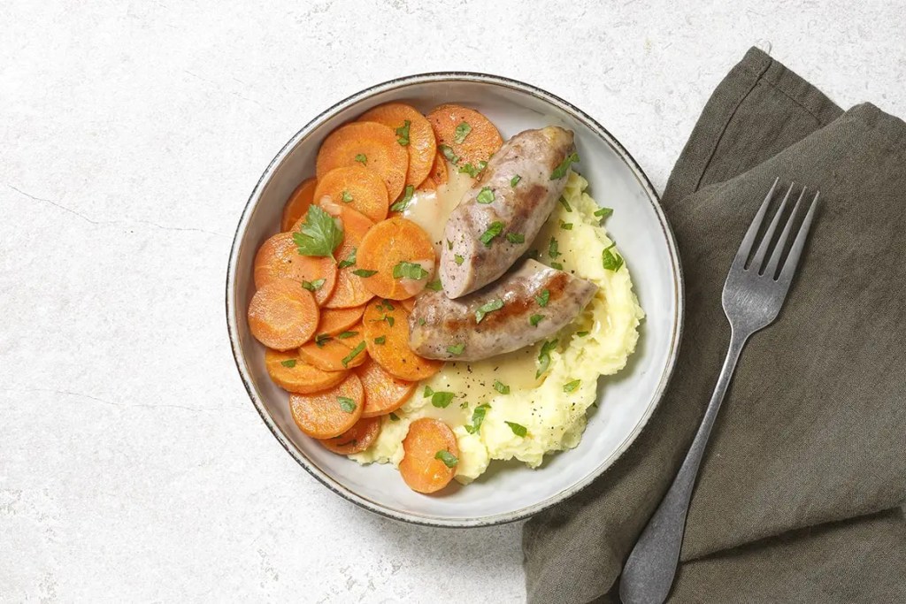 Plat Seazon : saucisse grillée label rouge, purée et volcan de sauce